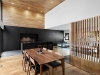 The living room, kitchen and dining room have been grouped together to form a large living area in the centre of the house | Photo credit: Annie Fafard + Maxime Moreau