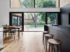 The white oak floors, in the same tone as the walls and ceilings, lend an inviting and warm character to the rooms | Photo credit: Annie Fafard + Maxime Moreau