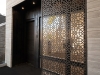 The anodized aluminum laser cut screen walls add an intricate detail to the modern shell of the building  | Photo by Greg Van Riel