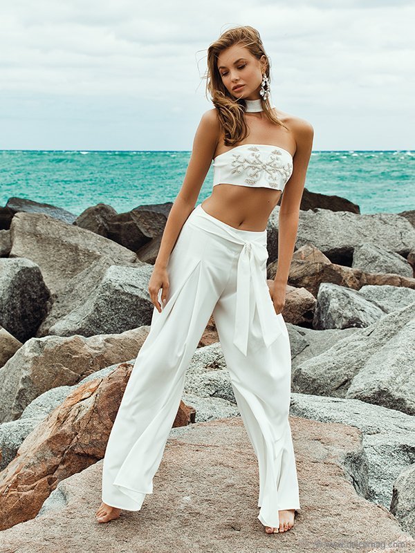 Chokers, bandeaus and flowing fabrics are all in. Combine them to create this summer’s signature look that speaks to a refined fearlessness / Earrings: Kendra Scott; top: BCBG; pants: Modest