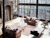 The reclaimed factory windows that front the home accentuate the volume of the space inside and infuse the home with beautiful natural light