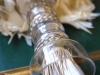 ​A custom-made curtain tie-back made of feathers, hand-blown glass, antique silver trim and fiberoptic strands / Photo by Geoff Fitzgerald
