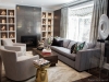 Sometimes more is more. Adding a light to each shelf and painting the interior a dark colour gives this fireplace wall with built-in shelving a sculpture-like feel, bringing depth and drama to the room