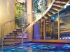 A curvy staircase spills onto the majestic Acqua Liana foyer for a lasting first impression.
