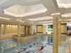 A tranquil pool and soothing hot tub is surrounded by Grecian-inspired architecture.