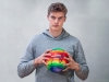 Chicago Bulls Player Lauri Markkanen in collaboration with Neste, holding a basketball with the world's heat map printed on it.