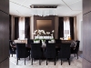 A low-profile geometric plaster design on the ceiling highlights an ethereal hand-cut white glass and polished nickel light fixture, navy velvet chairs by Kravet and a hand-knotted area rug by Weavers Art