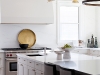 The kitchen features a bespoke ceiling light fixture by Ridgely Studio Works and a large-scaled hood and range that balances the great room’s fireplace design