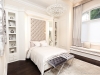 From the tufted headboard to the built-in bookcases and the custom drapery, this room illustrates the precision that went into the creation of this house | Photos by Carlos A. Pinto