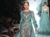 Awash with transparent feminine elegance, this sea green gown oscillates with lace, sequins and light embroideries.