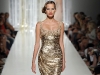 Dripping with glitz and glam, this couture cocktail dress by Tony Ward catches the eye with gold sequin embellishments and a train that will leave admirers starry eyed.