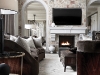 Chic and classic, this great room features a 25-foot soaring ceiling, stone walls infused with luxurious silk, and leather-wrapped door frames