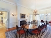 The grand dining room is ideal for entertaining, with breathtaking western views towards the pond, built-in speakers and fantastic display cases