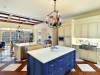 The kitchen spans the entire depth of the home and offers views over both the front courtyard and, to the west, the kitchen garden. The space is complemented by two center islands and several seating areas