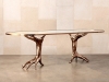 KELLY WEARSTLER DICHOTOMY RACETRACK TABLE: Inspired by classical figurative décor, this table knows how to make a statement. Its base is cast in bronze, and the glass on top is banded in a matching bronze trim | Photo courtesy of Kelly Wearstler