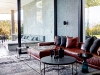 The home’s cinema lounge, which opens onto a covered patio, is made intimate and cosy with grass cloth wallpaper and a Paco rug. The Calvinia coffee table and Cube side table are by Tonic Design