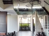 As you enter the house a powerful and arresting space opens up to a triple-volume, seven-metre-high living area framed on either side by walnut-clad floating staircases with frameless glass balustrades