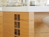 A wine rack has been incorporated into the end of this teak kitchen island.
