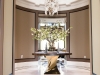 Below, the luxurious entrance space of another successful JTF Homes build features a timeless custom water jet in a cut marble slab foyer | Photos Courtesy Of JTF Homes