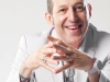 Wearing an all-white ensemble, this coulorless attire is a sharp contrast to the generally flamboyant products and spaces Karim Rashid creates. Photography by Di. Bi