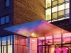 A warm pink glow accents the oversized pink “n” that welcomes guests at the entrance of the Nhow Hotel. Photography by Lukas Roth