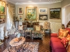 An assortment of sculptures dot his eclectic living room, as well as art pieces by Miller Brittain (left) and Fred Ross (centre)
