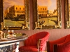 Addison Mizner-inspired entrance; ultra-luxe, intimate lobby bar.