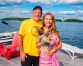 Canadian Sports Commentator Rod Black and TV Personality Joan Kelley Walker (with pup!) enjoying the water-based Dock-to-Dock party atmosphere (photo: George Pimental)