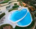 The two-tiered pool is an example of how the villa fits into the contour of its location | Photo By Massimo Camplone
