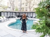koifman poses in a black caftan by her backyard pool