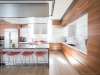 Contemporary kitchen with stainless steel accents, finished in a combination of flat-cut American black walnut and matte lacquer. designed by EAC Design. Fabricated and installed by NIICO | Photos by Vanessa Galle