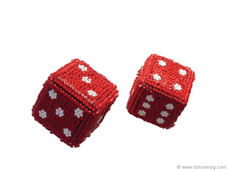 Made from red and white crayons, Herb William’s The Color of Luck dice literally melds tools of art with tools of chance – and the result is nothing short of a winner.