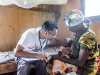 mother holds her child during an examination by dr raghu venugopal