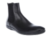 MacPhee slips on his black leather Prada Chelsea boots to give him that extra kick.