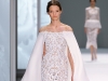 spring-summer-2015-collection-10An off-the-shoulder, white silk crepe cape frames the décolleté as it spills over a hip-hugging guipure lace and glass bead gown