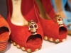Alexander McQueen’s skull-embellished red suede pumps with gold studs can’t sit still on her shelves
