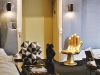 Saghian mixes in eye-catching pieces, such as this golden metallic hand chair and driftwood coffee table, to illicit “Oh! Where did you find that?” responses from those who enter his eclectically-tasteful spaces