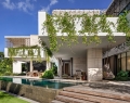 Large covered outdoor spaces define Terracina on Golden Island in Miami with outdoor landscaped rooms offering views up the Intercoastal Waterway | Photo By Adam Letch