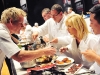 Ramsay meticulously samples the various entrées prepared by each team.