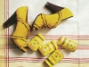 Spice up your step with these bold, mustard-yellow suede peep-toes. With their fringed, zigzag details; wooden-looking, leather wrapped heels and hue, the fall leaves will have some competition.