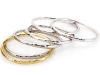 Lustrous sterling silver and 18-karat gold “Martellato” bangles will gracefully adorn your delicate wrist while catching sun and all the right attention.