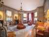 A delicate crystal chandelier complements this space’s sovereign décor. Photo courtesy of Burger Sotheby\'s International Realty