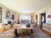 Light fills this inviting living room, which seamlessly transitions to the sea. Photo courtesy of Burger Sotheby\'s International Realty