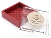 THINK OUTSIDE THE BIRKS Rest your precious jewels in this alluring red leather box from Birks, adorned with a delicate ivory flower.