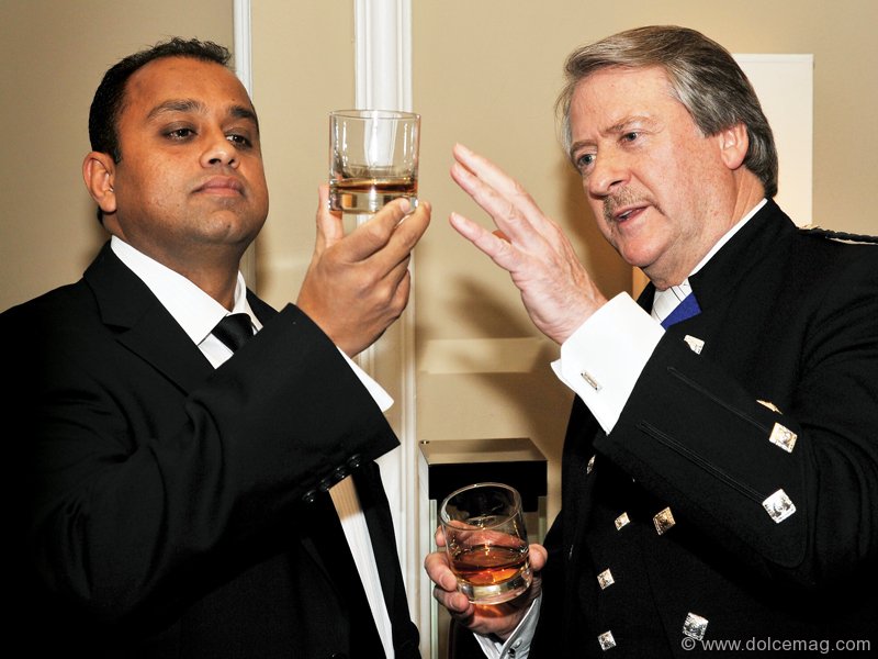 Mahesh Patel analyses the colour of fine whisky next to master blender Richard Paterson.