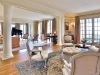 The warm oak flooring continues into the great room, which also features imported silk wall coverings
