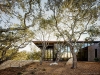 Tehama 1: The front door is accessed via concrete stairs that ascend the gently sloping site. The home's entryway is enclosed in floor-to-ceiling glass | Photo credit: Joe Fletcher Photography