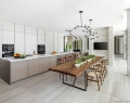 A custom-made table seating up to 10 is the focal point of a sleek, clean and contemporary open-plan kitchen and dining area | Photo By Kris Tamburello Studios