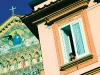 An Italian woman gazes out her window beside the cathedral of St. Andrew in Amalfi Village. Photo by Robert Leon