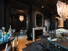 A double-sided fireplace overlooks the formal dining area of the Rockstar Suite